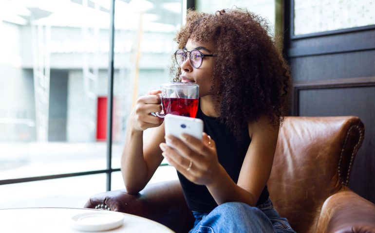 beautiful-young-woman-drinking-coffee-in-cafe-VMBEPXH.jpg